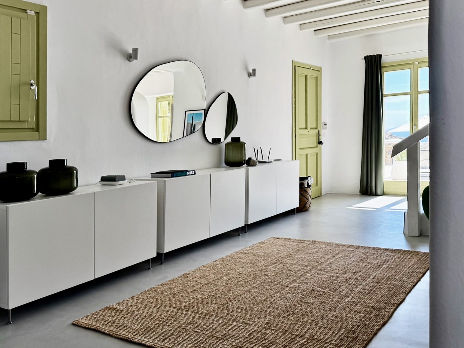 Villa AGNES living room with round mirrors and jute rug