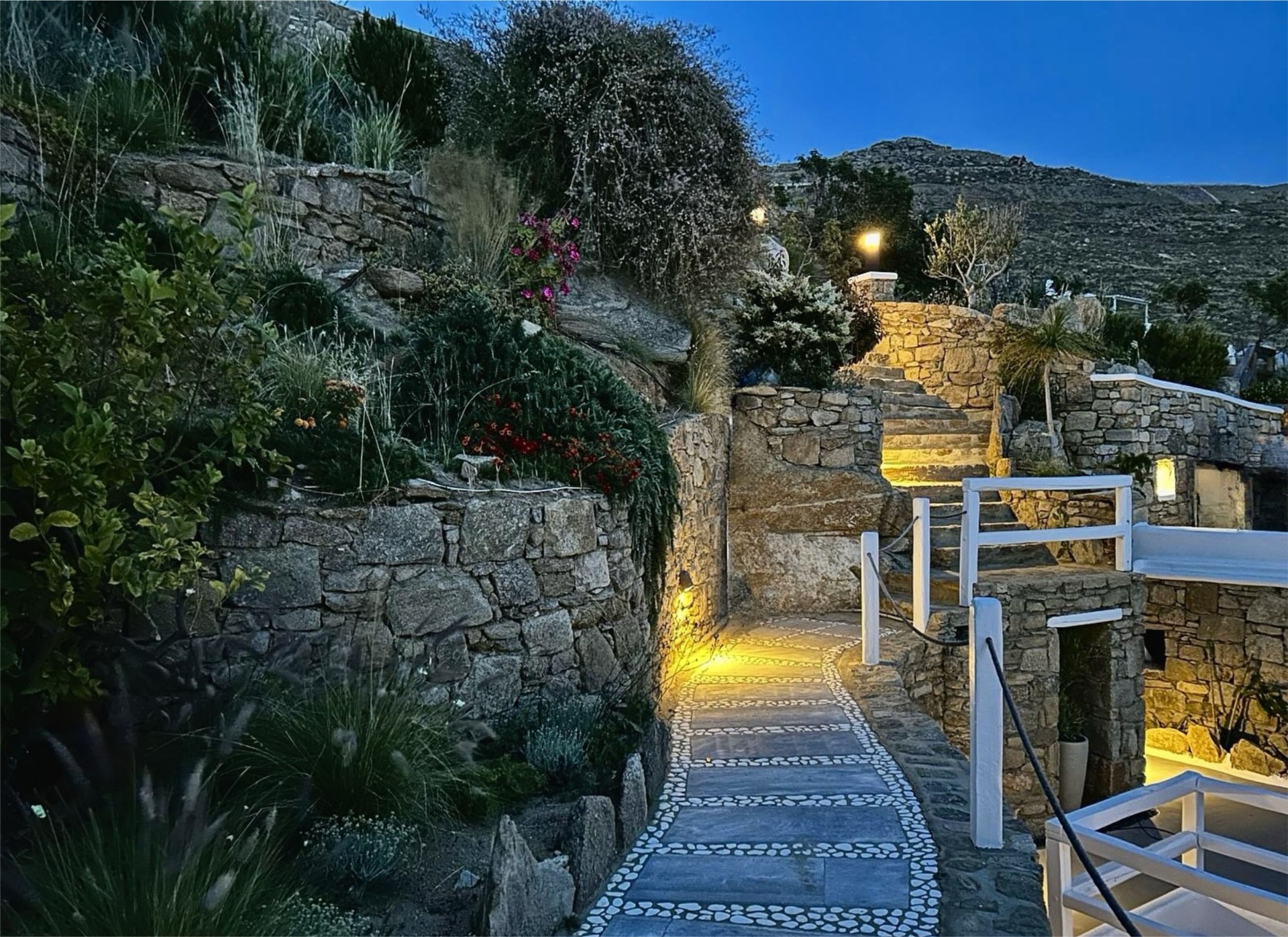 Villa AGNES pebble pathway and stone garden walls at dusk