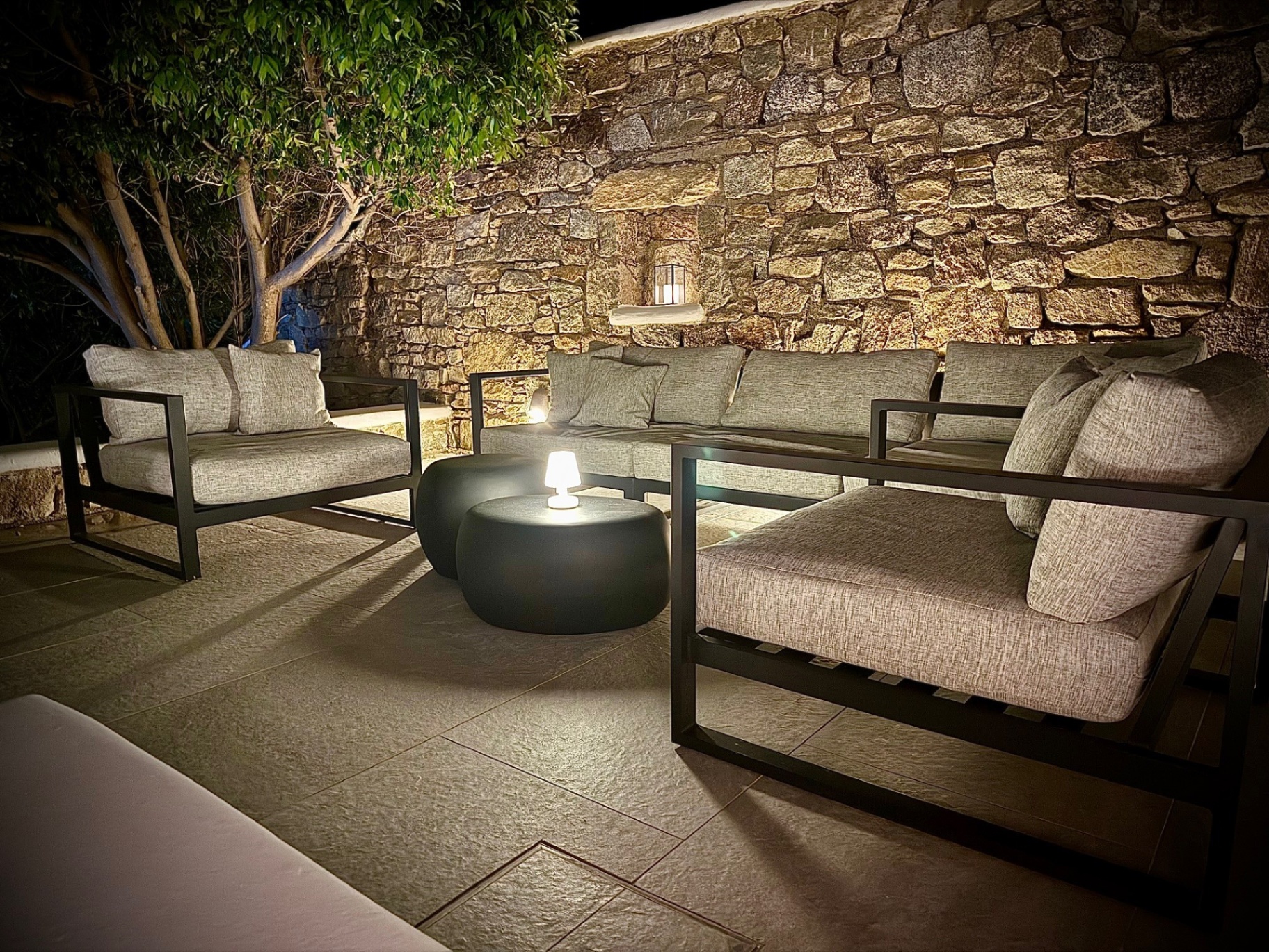 Villa AGNES outdoor lounge by the stone wall