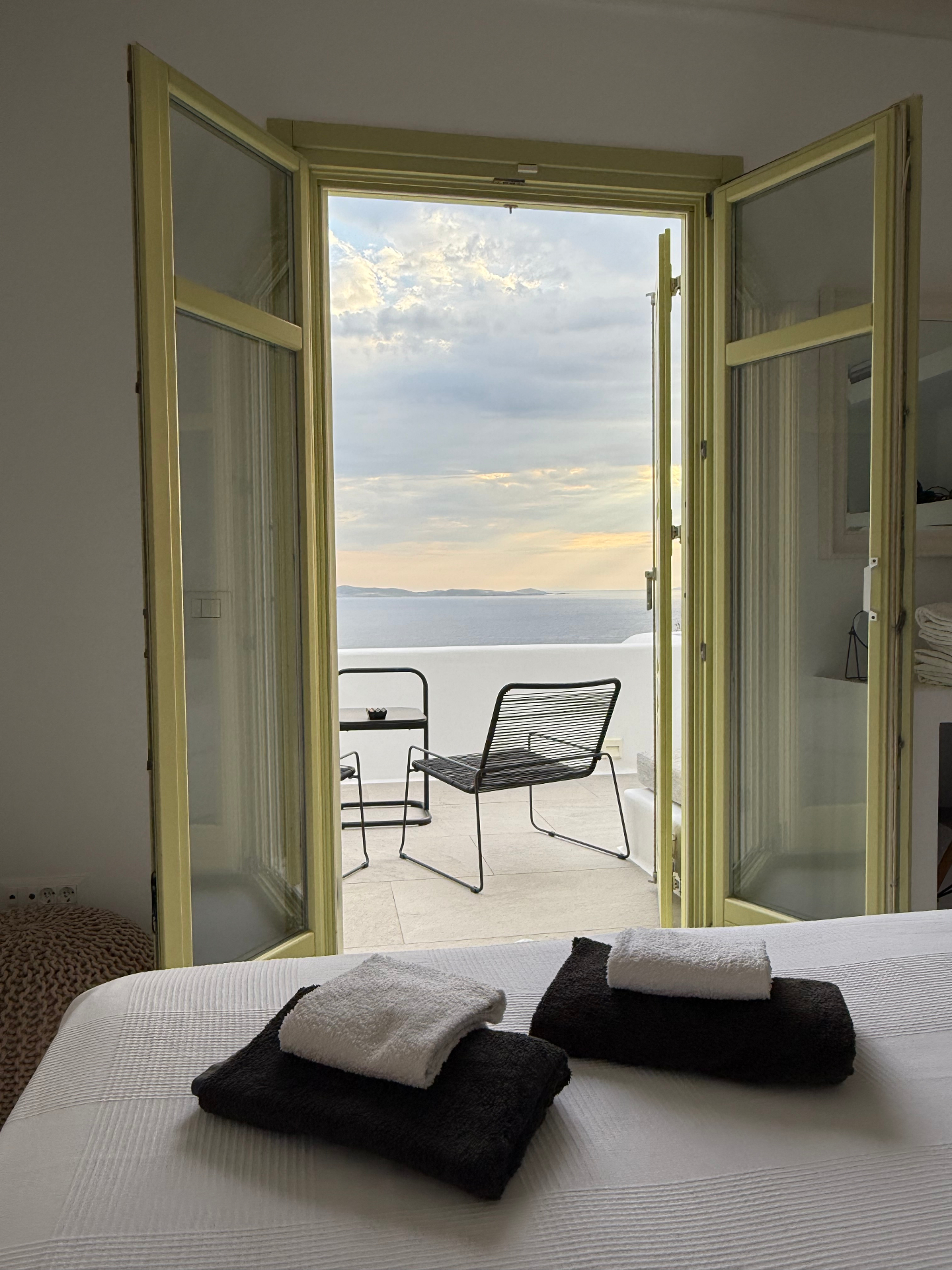 Villa AGNES bedroom doors opening onto sea-view terrace at sunset